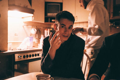 Portrait of young man sitting at restaurant