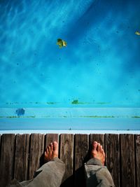 Low section of man swimming in sea