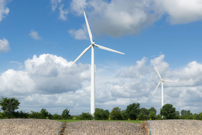 Windmill on field against sky