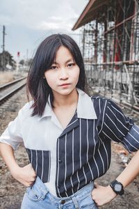 Young woman looking down while standing outdoors