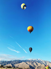 Low angle view of hot air balloons against sky