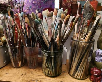 High angle view of paintbrushes in jar on table