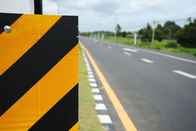 Close-up of signboard by road