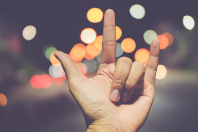 Close-up of hand at night