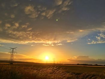 Scenic view of field against sky during sunset