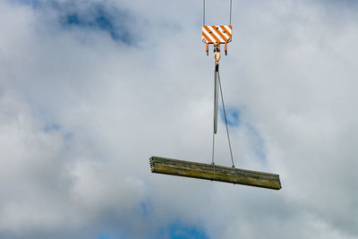 Low angle view of crane against sky