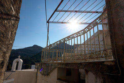 Low angle view of bridge against buildings against sky