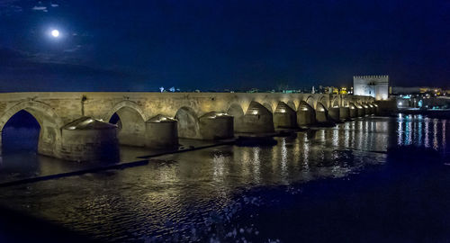 Reflection of illuminated built structure in water
