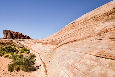 Scenic view of desert against clear blue sky