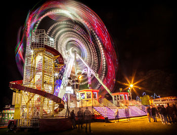 Illuminated ferris wheel at night