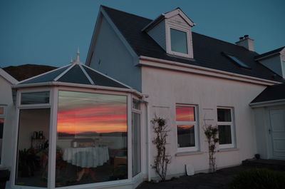 House against sky during sunset