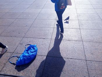 Low section of people walking on street