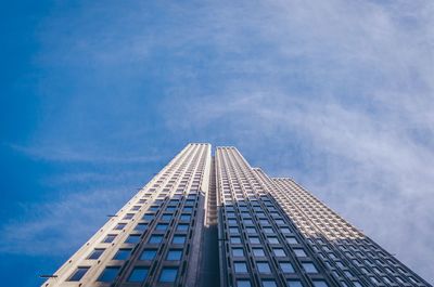 Low angle view of modern building against blue sky