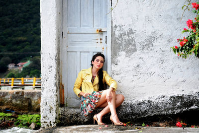 Portrait of smiling woman sitting outdoors