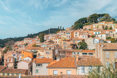 Houses in town against sky