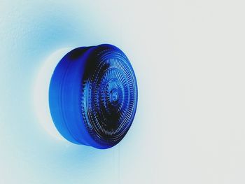 Extreme close up of blue light against white background