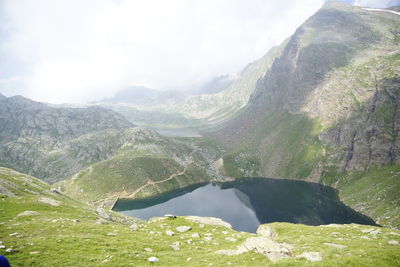 Scenic view of lake and mountains against sky