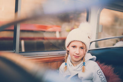 Portrait of girl sitting in bus