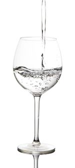 Close-up of wineglass on glass against white background