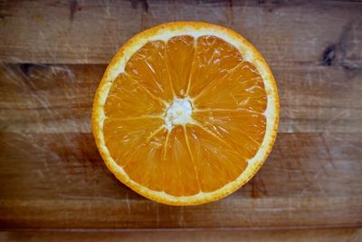 Close-up of lemon slice on wood