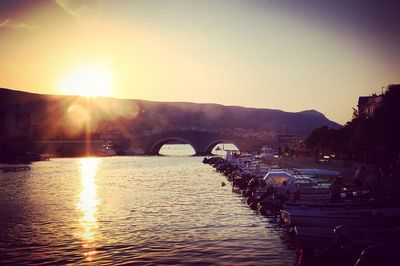 Bridge over river at sunset