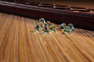 Close-up of marble balls by wooden containers on table