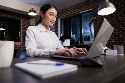 Businesswoman using laptop on table