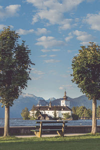 Built structure by trees against sky