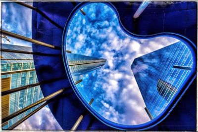 Low angle view of buildings against cloudy sky