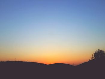 Scenic view of silhouette mountains against clear sky