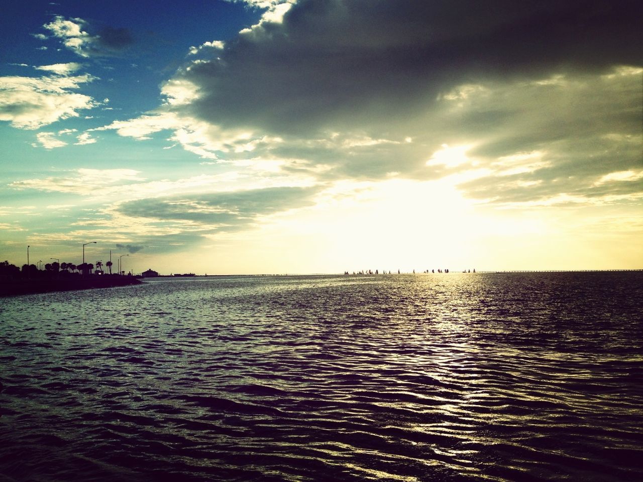 water, sea, sky, waterfront, tranquil scene, scenics, tranquility, sunset, rippled, beauty in nature, cloud - sky, nature, cloud, idyllic, horizon over water, sunlight, silhouette, cloudy, sun, outdoors