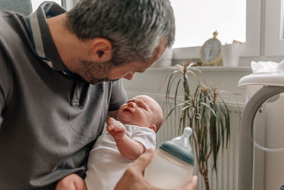 Father holding crying baby in his arms