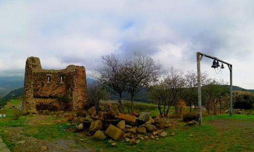 Old ruins on field against sky