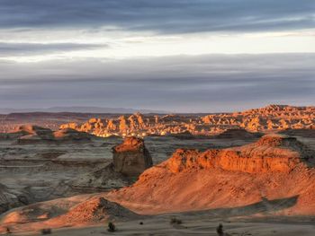 Scenic view of desert against sky during sunset