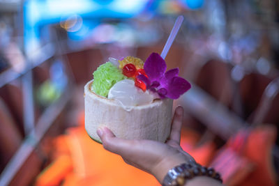 Close-up of hand holding ice cream