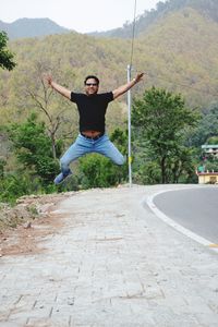 Full length of man jumping on mountain