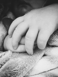 Close-up of hands holding baby hand