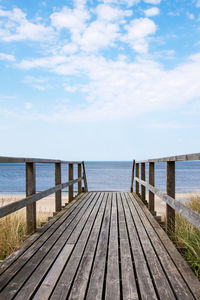 Pier over sea against sky