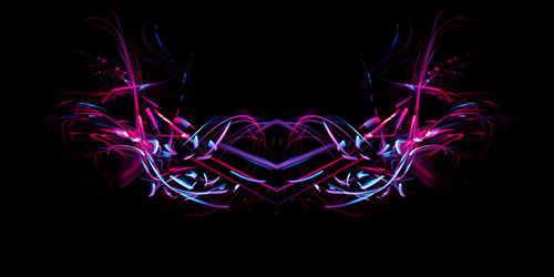 Illuminated light painting against sky at night