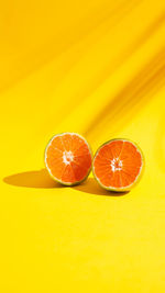 Orange fruits against yellow background