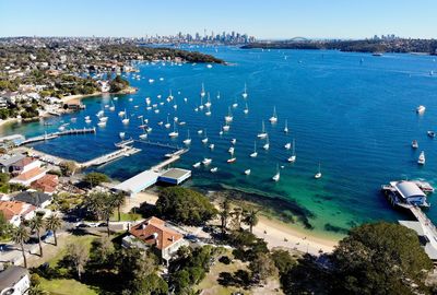 High angle view of sailboats on sea in city