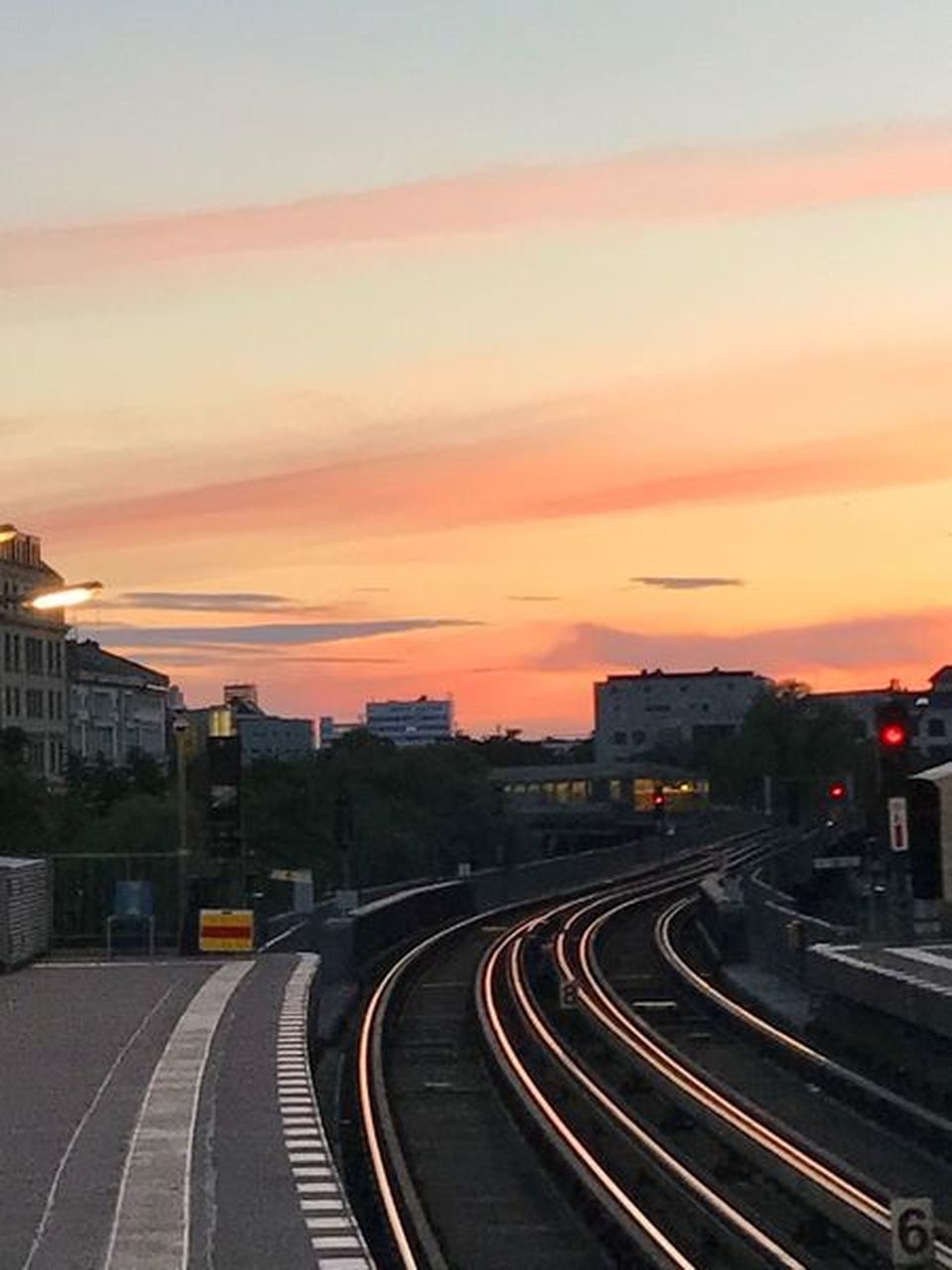 VIEW OF RAILROAD TRACKS IN CITY AGAINST SKY