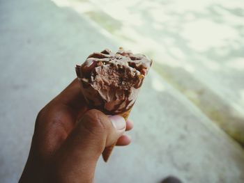 Close-up of hand holding ice cream cone