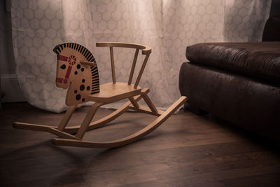 Rocking horse by sofa at home