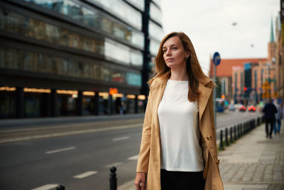 Portrait of young woman standing outdoors