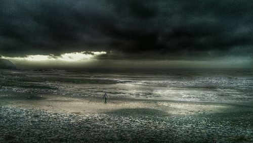 Scenic view of sea against cloudy sky