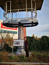 Full length of woman standing by plants against sky