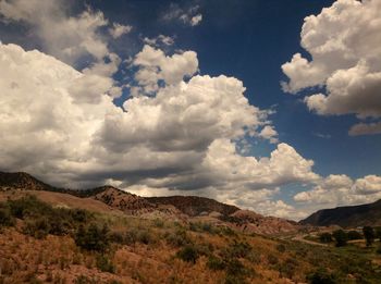 Scenic view of mountains against cloudy sky