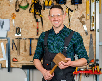 Portrait of young man standing in workshop