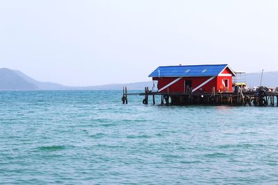 Hut with sea and mountain in background